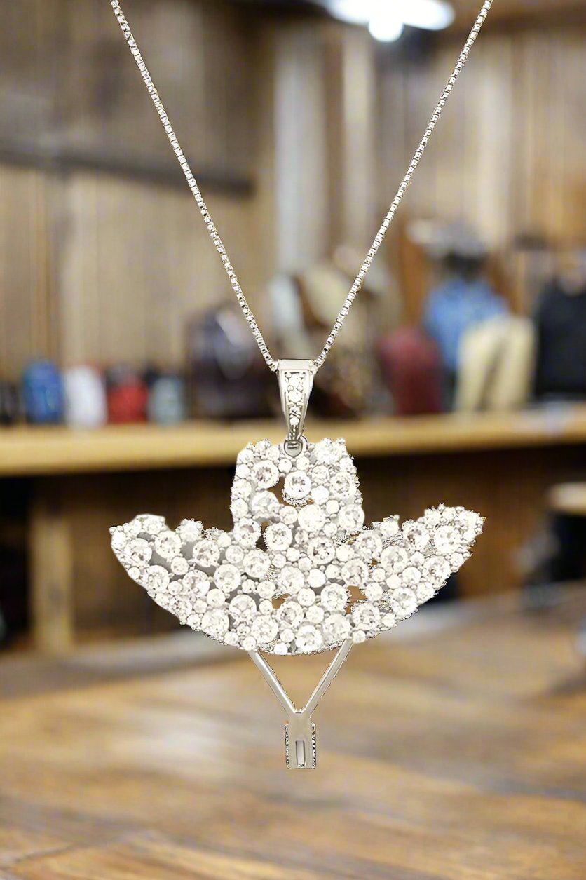 Cubic Zirconia Cowboy Hat Pendant NecklaceLeanne Roberts DesignsCubic Zirconia Cowboy Hat Pendant NecklaceDazzle and delight with this stunning necklace featuring a sparkling Cubic Zirconia cowboy hat pendant. The 18" length and extension make it a versatile accessory fo